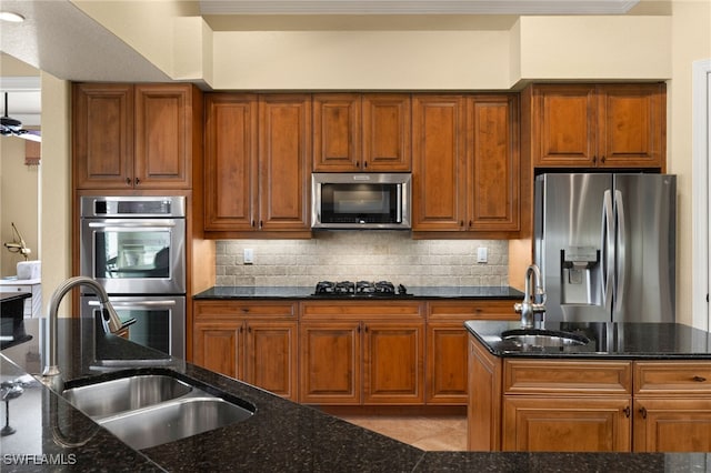 kitchen featuring backsplash, stainless steel appliances, and a sink