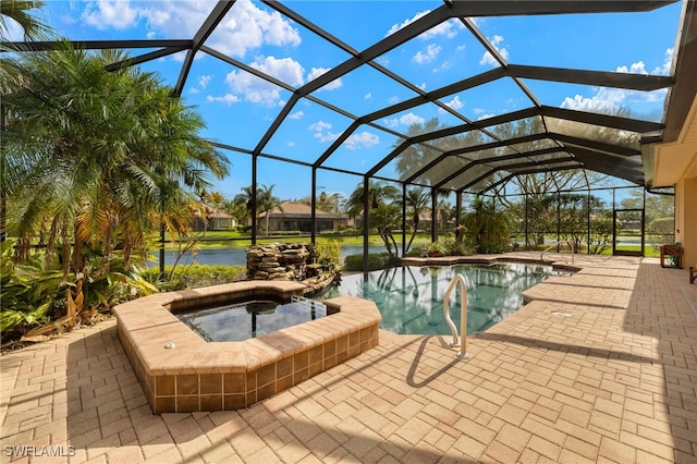 pool featuring a lanai, a patio area, and an in ground hot tub