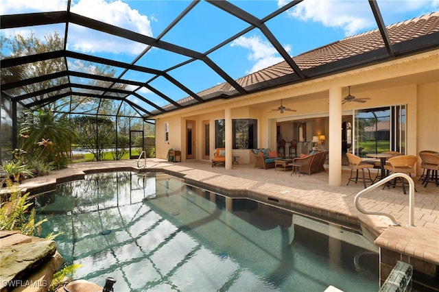 pool with a patio area, glass enclosure, an outdoor hangout area, and a ceiling fan