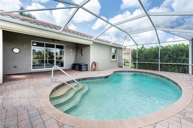 pool with a patio area, a lanai, and ceiling fan