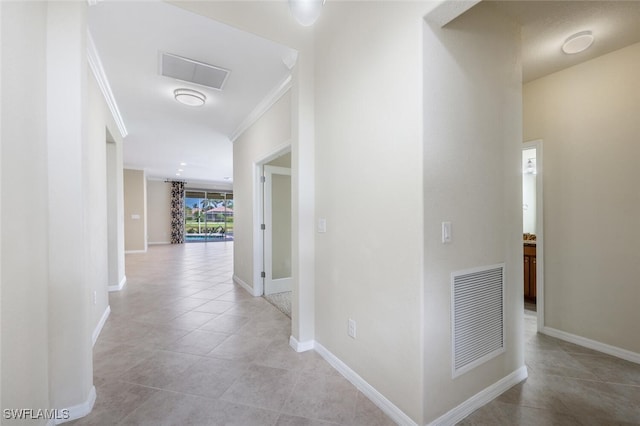 14783 Cranberry Ct, Naples, FL 34114 - corridor featuring light tile patterned floors, baseboards, and crown molding