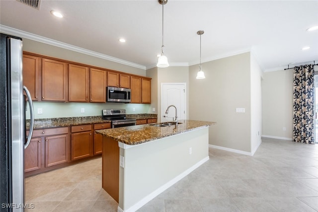 kitchen featuring dark stone counters, brown cabinetry, appliances with stainless steel finishes, and a sink