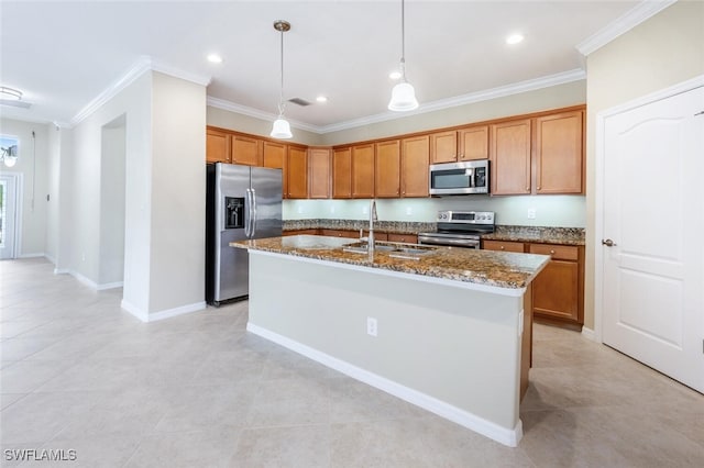 kitchen with ornamental molding, dark stone countertops, appliances with stainless steel finishes, brown cabinetry, and a sink