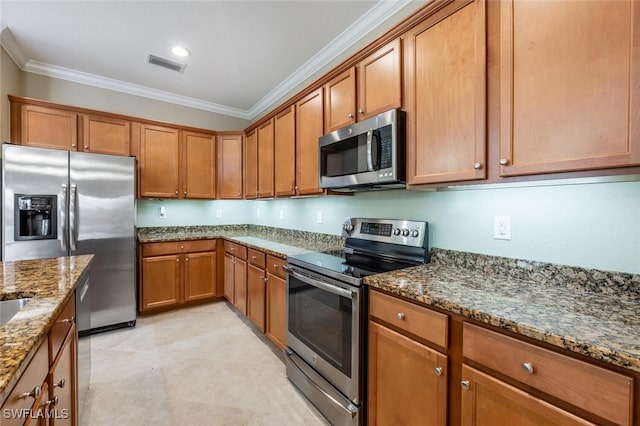 kitchen with visible vents, dark stone counters, ornamental molding, stainless steel appliances, and brown cabinets