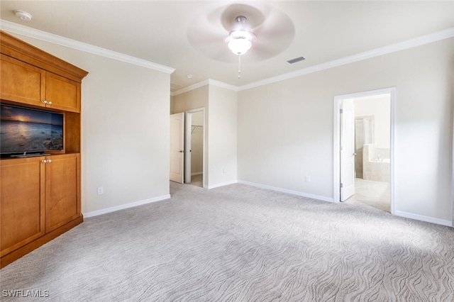 unfurnished bedroom featuring visible vents, connected bathroom, crown molding, baseboards, and light colored carpet