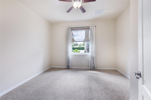 carpeted spare room featuring baseboards and ceiling fan