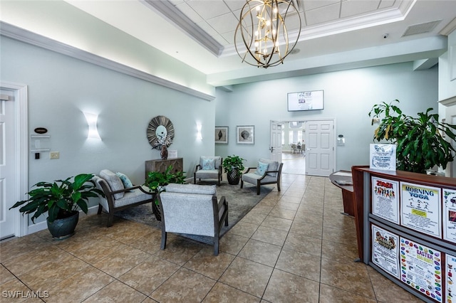 tiled living area featuring a tray ceiling, a notable chandelier, visible vents, and ornamental molding