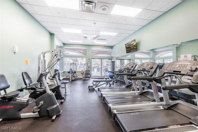 exercise room with a healthy amount of sunlight, visible vents, and a drop ceiling