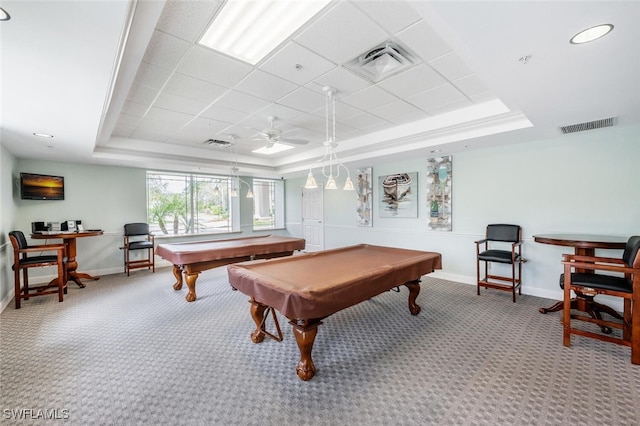 rec room featuring a tray ceiling, baseboards, visible vents, and carpet flooring