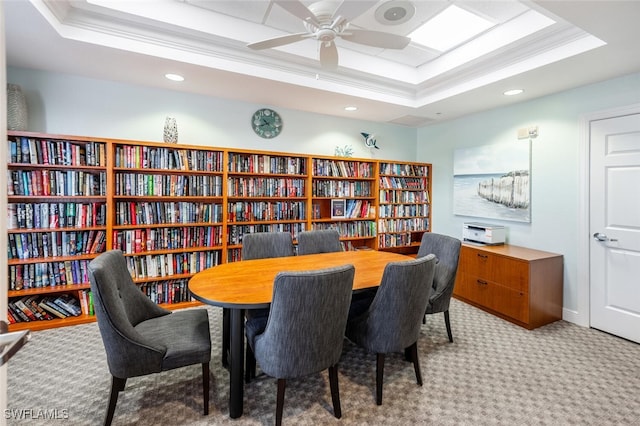 carpeted office featuring recessed lighting, crown molding, a raised ceiling, and wall of books