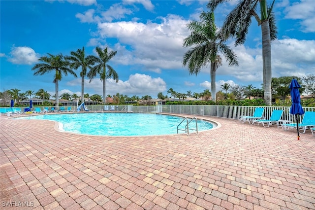 pool featuring a patio area and fence