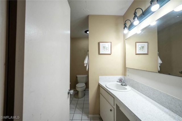 bathroom with vanity, tile patterned flooring, and toilet