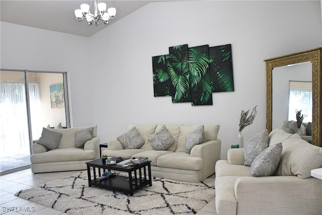 living area with lofted ceiling, a notable chandelier, and tile patterned floors