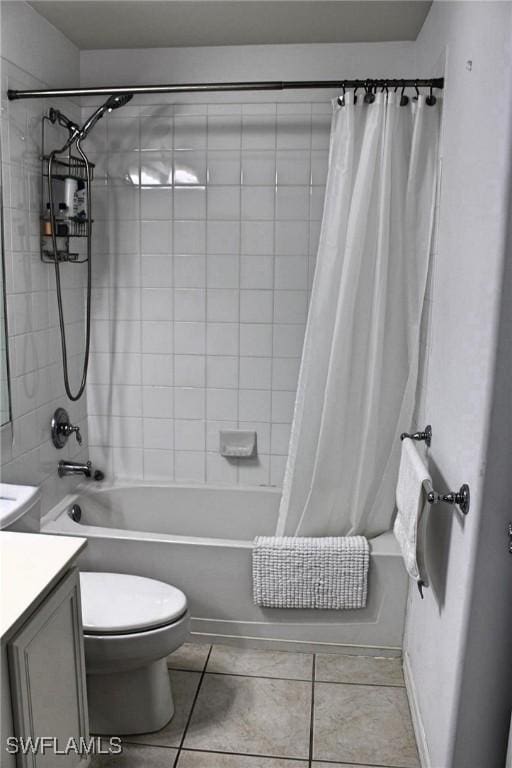 bathroom with tile patterned flooring, vanity, toilet, and shower / tub combo with curtain