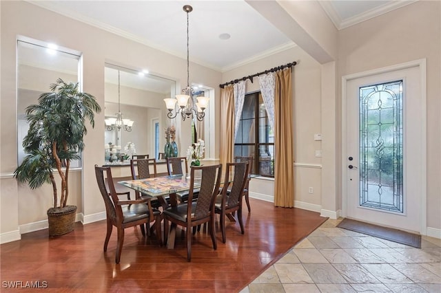 dining room with baseboards, ornamental molding, a chandelier, and wood finished floors