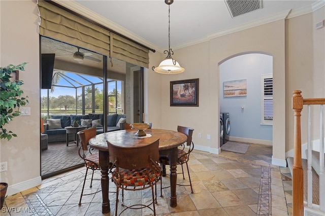 dining space featuring crown molding, visible vents, a sunroom, separate washer and dryer, and baseboards