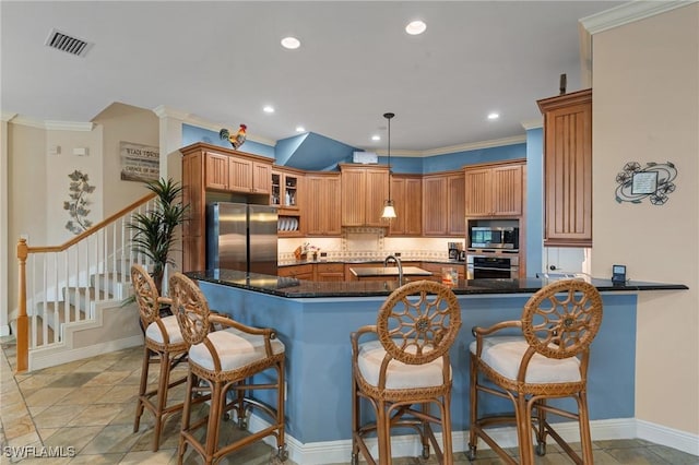 kitchen featuring visible vents, glass insert cabinets, brown cabinets, ornamental molding, and stainless steel appliances