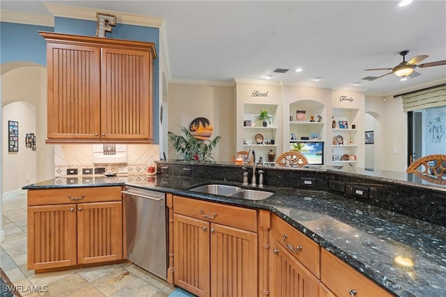 kitchen with arched walkways, crown molding, a sink, dark stone counters, and dishwasher