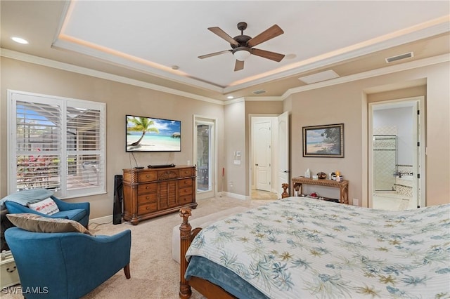 bedroom featuring visible vents, a tray ceiling, crown molding, and light colored carpet