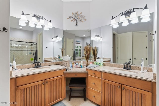 full bath featuring a stall shower, two vanities, a sink, and tile patterned floors