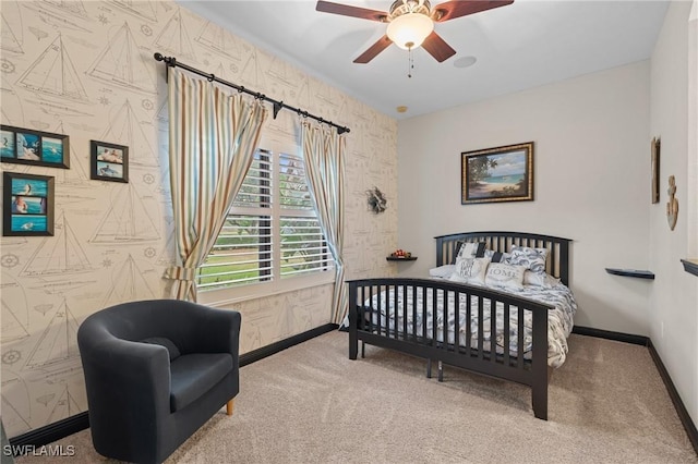 carpeted bedroom featuring a ceiling fan, baseboards, and wallpapered walls