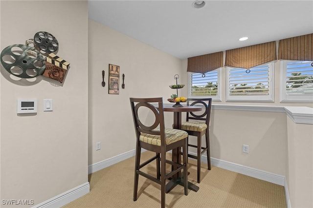 dining area with recessed lighting, light carpet, and baseboards