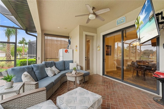 sunroom featuring ceiling fan