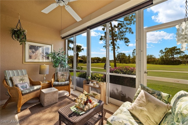 sunroom featuring vaulted ceiling, plenty of natural light, and a ceiling fan