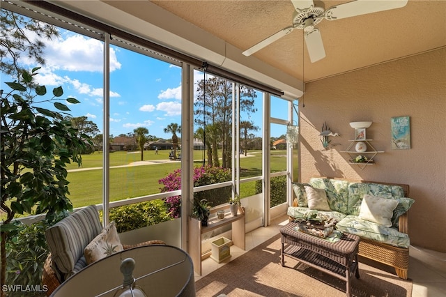 sunroom featuring ceiling fan and lofted ceiling