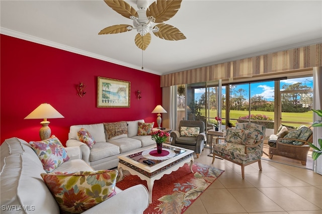 living area featuring tile patterned flooring, an accent wall, a ceiling fan, ornamental molding, and wallpapered walls