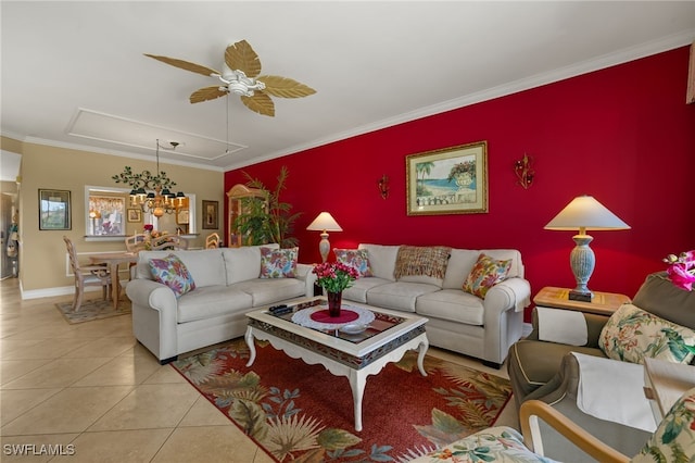 living room with crown molding, light tile patterned floors, an accent wall, a ceiling fan, and baseboards