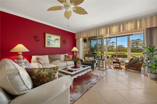 living room with an accent wall, tile patterned flooring, ornamental molding, and a ceiling fan