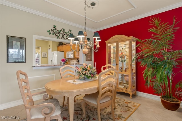 dining space with light tile patterned floors, baseboards, an accent wall, and a chandelier