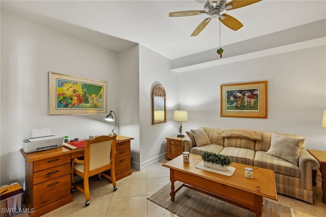 living area featuring ceiling fan, baseboards, and light tile patterned flooring