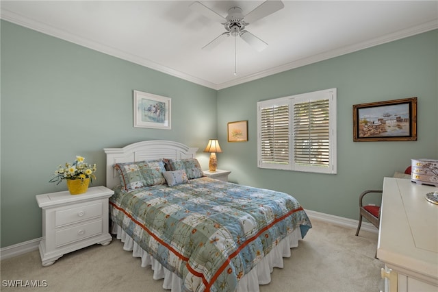 bedroom featuring ornamental molding, light colored carpet, baseboards, and a ceiling fan