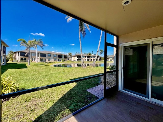 unfurnished sunroom with a water view