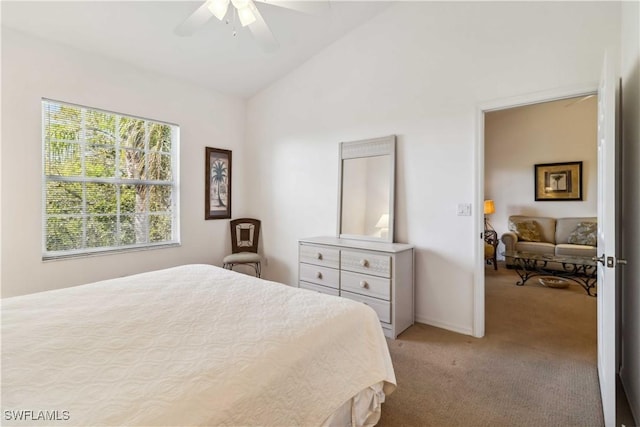 bedroom featuring baseboards, vaulted ceiling, a ceiling fan, and light colored carpet