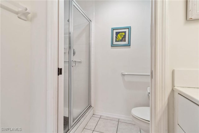 bathroom with toilet, a shower stall, and tile patterned flooring