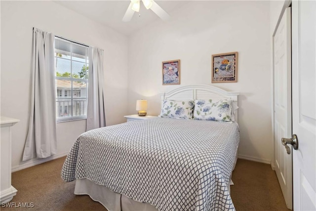 carpeted bedroom featuring baseboards and a ceiling fan