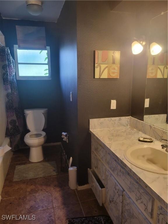 full bath featuring tile patterned flooring, vanity, and toilet