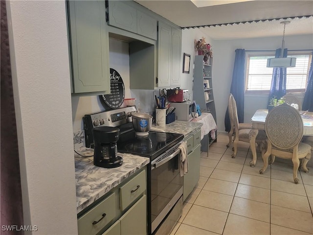 kitchen with stainless steel electric range oven, light tile patterned flooring, and pendant lighting