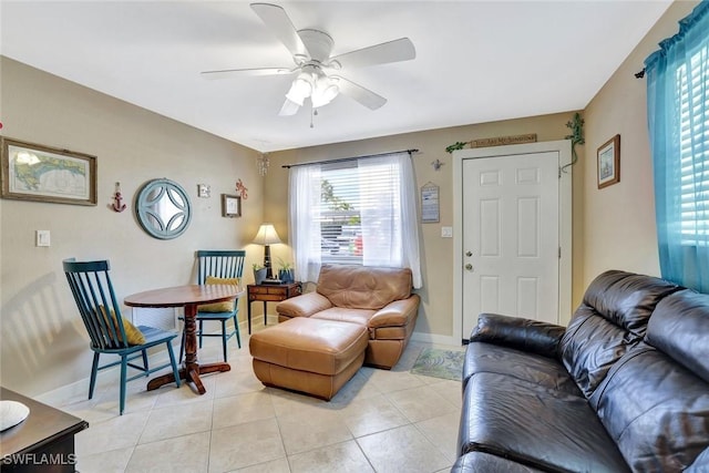 living area with ceiling fan, light tile patterned flooring, and baseboards