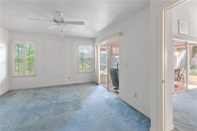 empty room featuring carpet flooring, a ceiling fan, and baseboards