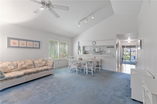 carpeted living area with high vaulted ceiling, a healthy amount of sunlight, and ceiling fan