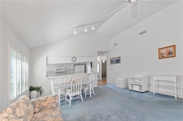 interior space with a ceiling fan, visible vents, and high vaulted ceiling