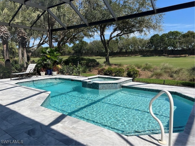 view of pool featuring a pool with connected hot tub, a patio, a lanai, and a lawn