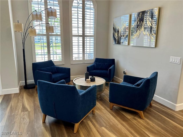 living area featuring baseboards and wood finished floors