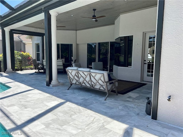 view of patio / terrace with a lanai, ceiling fan, and outdoor lounge area