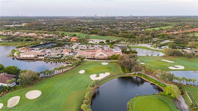 birds eye view of property featuring view of golf course and a water view