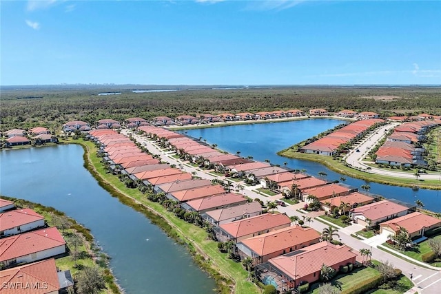 drone / aerial view with a water view and a residential view